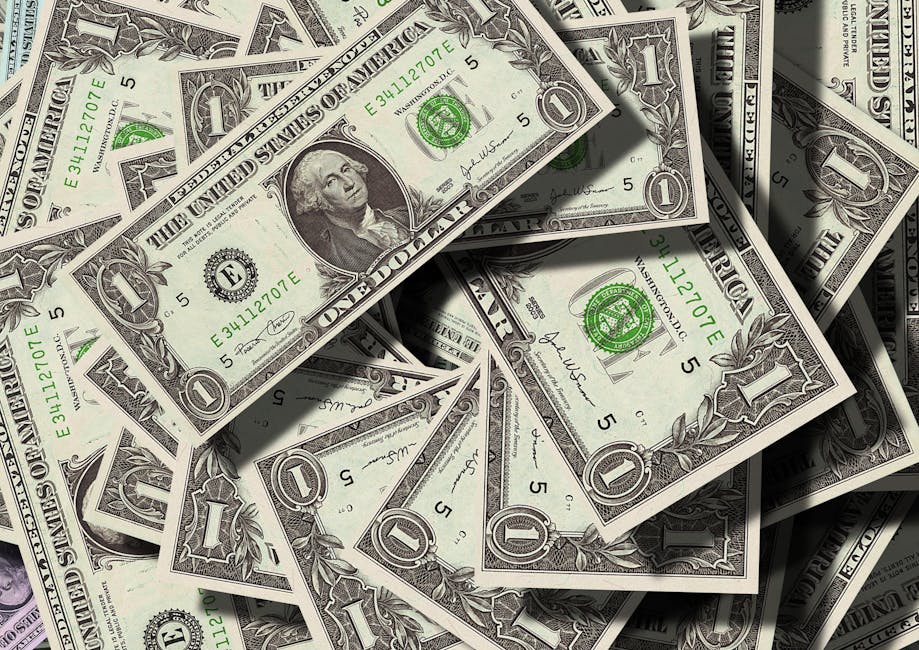 Close-up of scattered US dollar bills symbolizing finance and wealth.