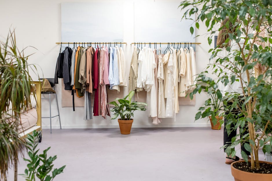 Chic fashion boutique showcasing vibrant clothing collection with lush indoor plants. capsule wardrobe