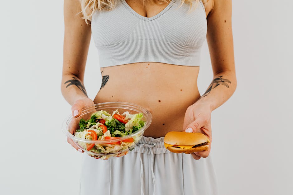 A woman in a sports bra holding a salad and cheeseburger, representing healthy vs junk food choices. Conscious Choices