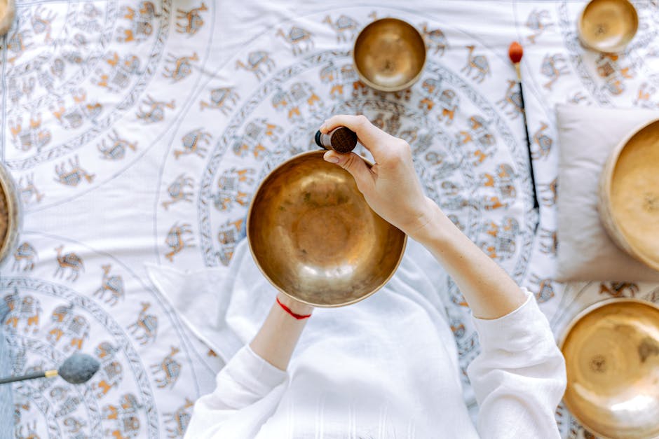 A top-down view of meditation using a Tibetan singing bowl for relaxation and healing.